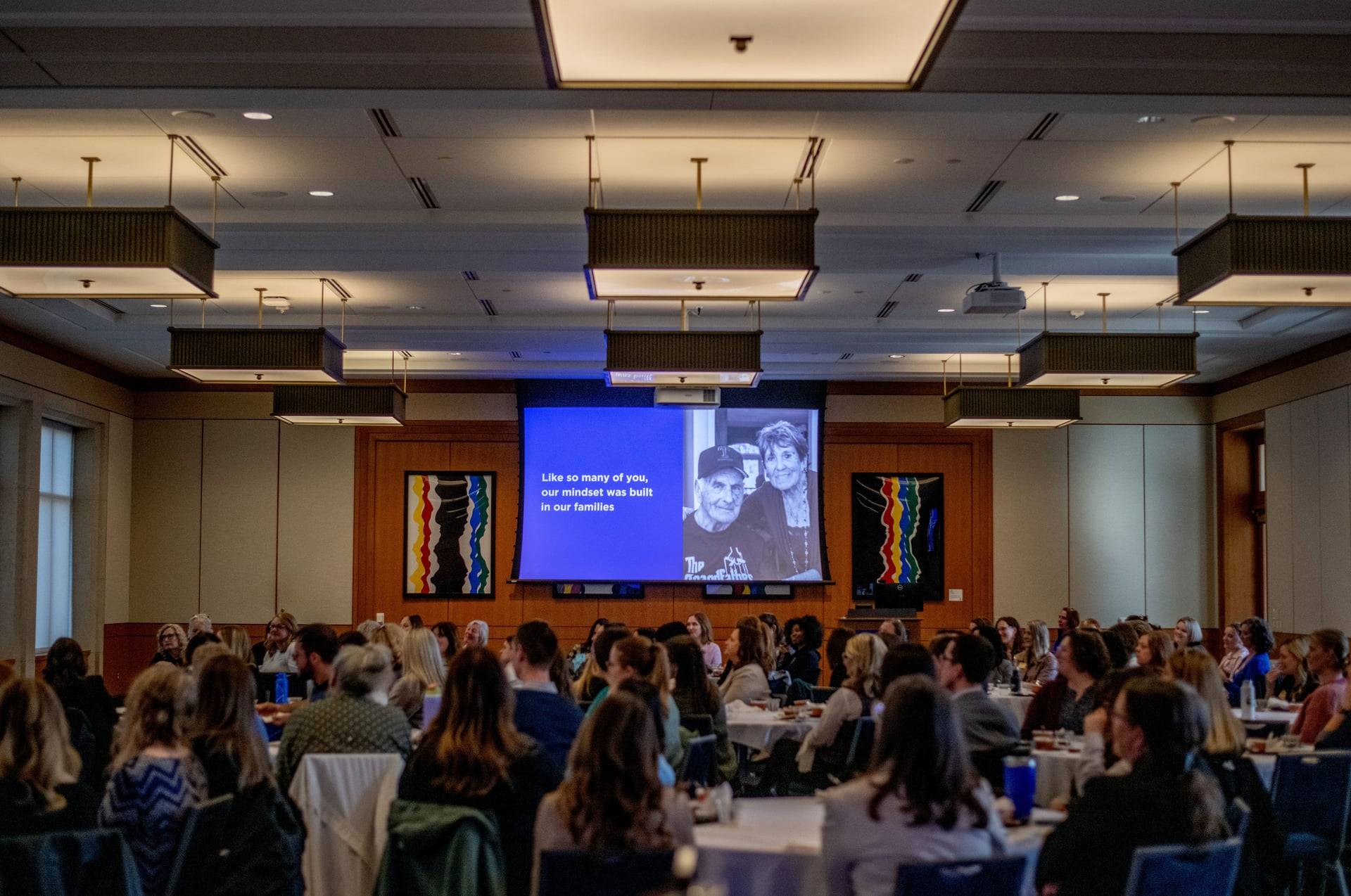 Crowd facing a presentation screen